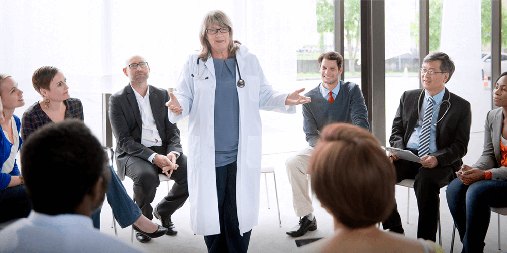 Instructor speaking to room of professionals